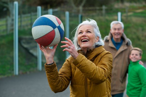 Senior playing basketball