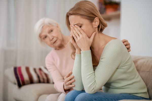 Woman being comforted by senior